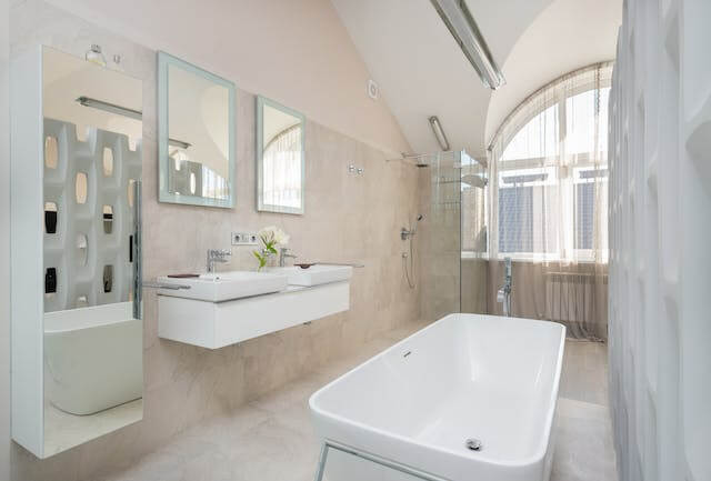 Imagem de um banheiro limpo e organizado, com uma enorme banheira, e o principal: Livre de entupimento graças a Empresa de Limpeza de Esgoto.